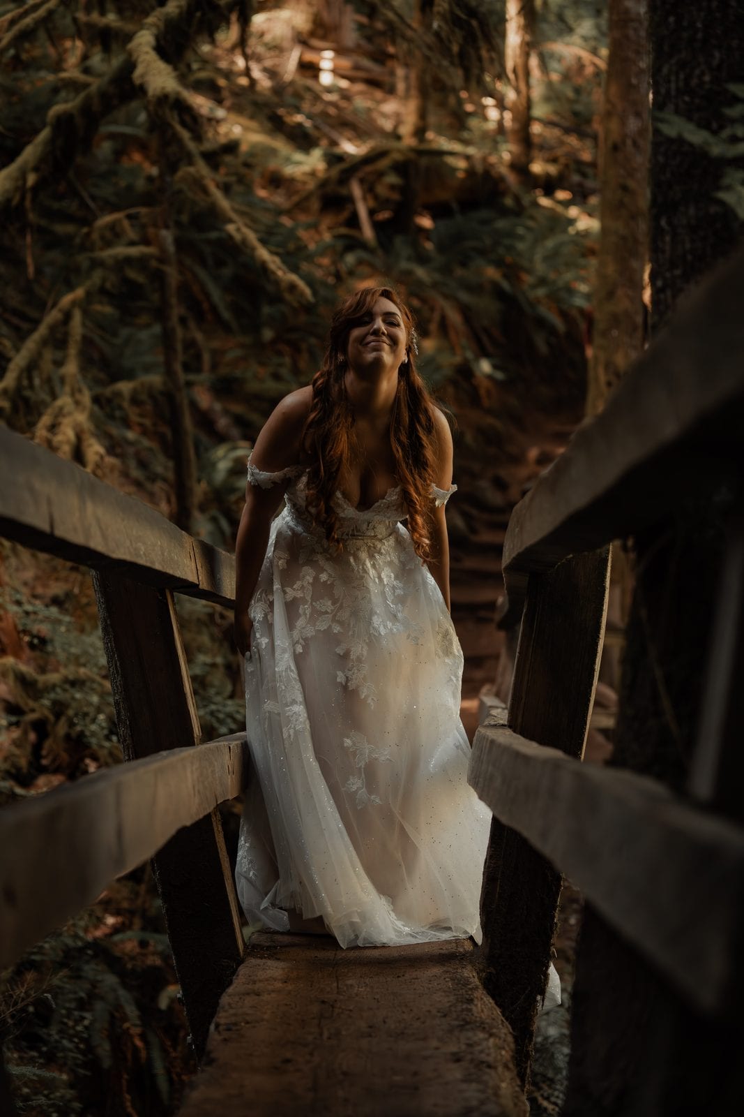 The bride laughing on the footbridge