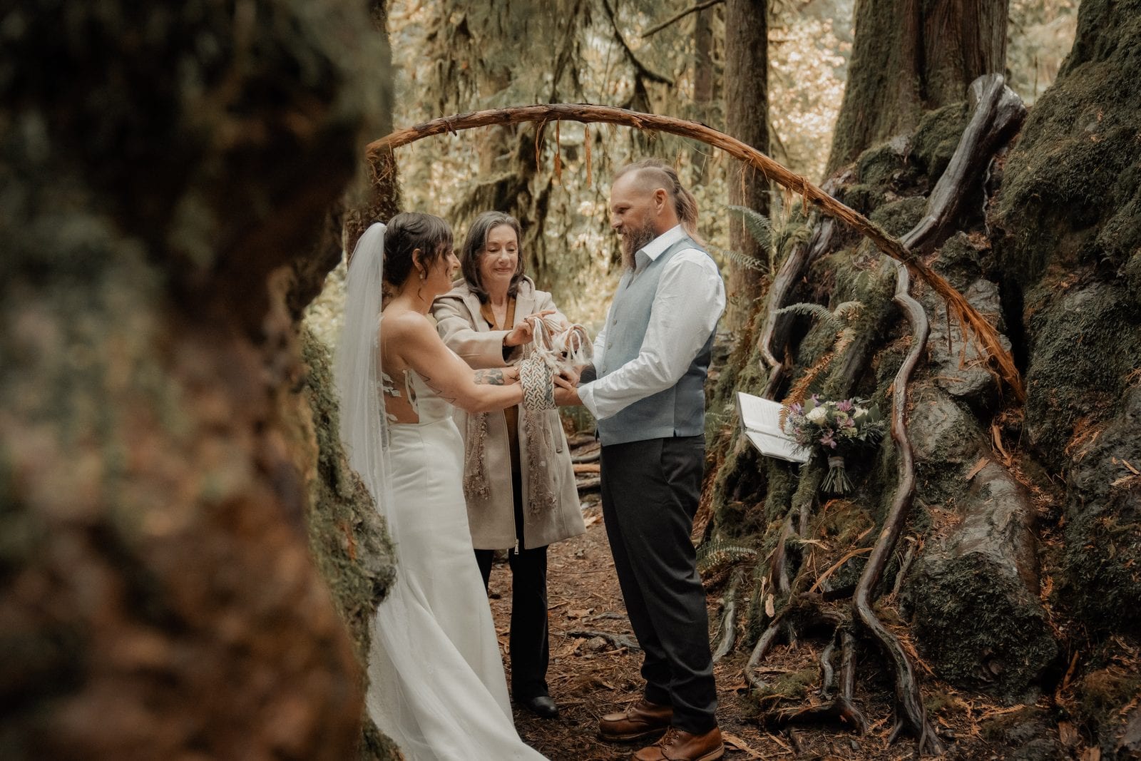 The ceremony beneath a forest arch
