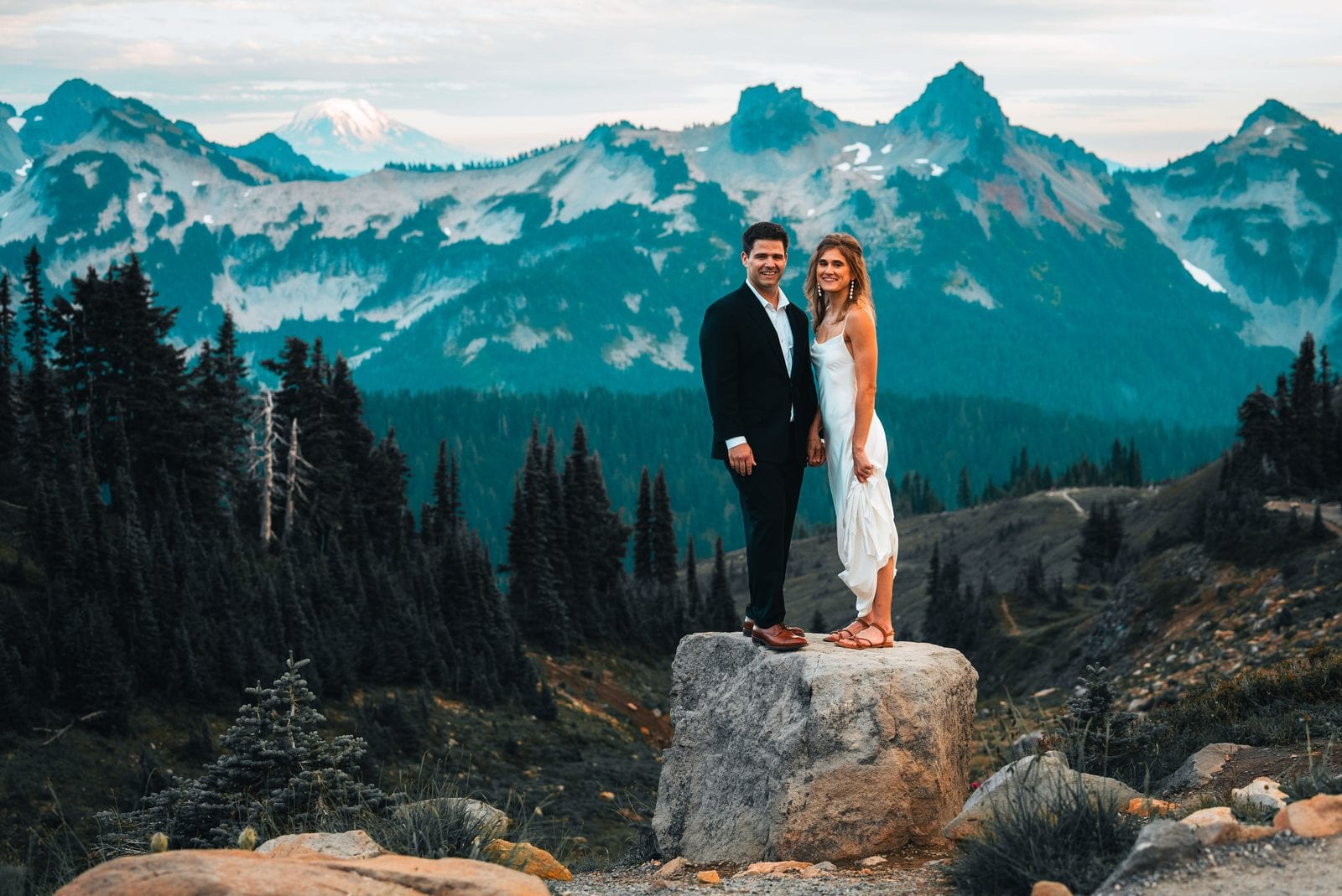 The couple on a rock outcrop above the valley