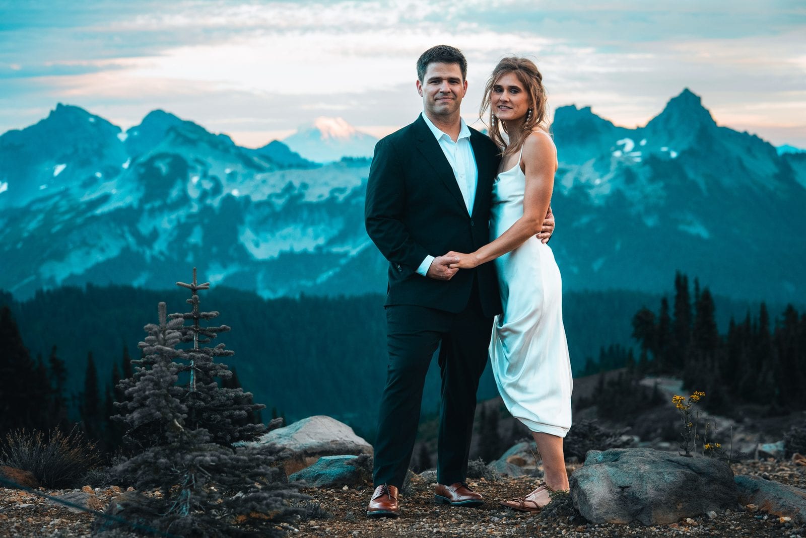 The couple hand in hand in the mountains