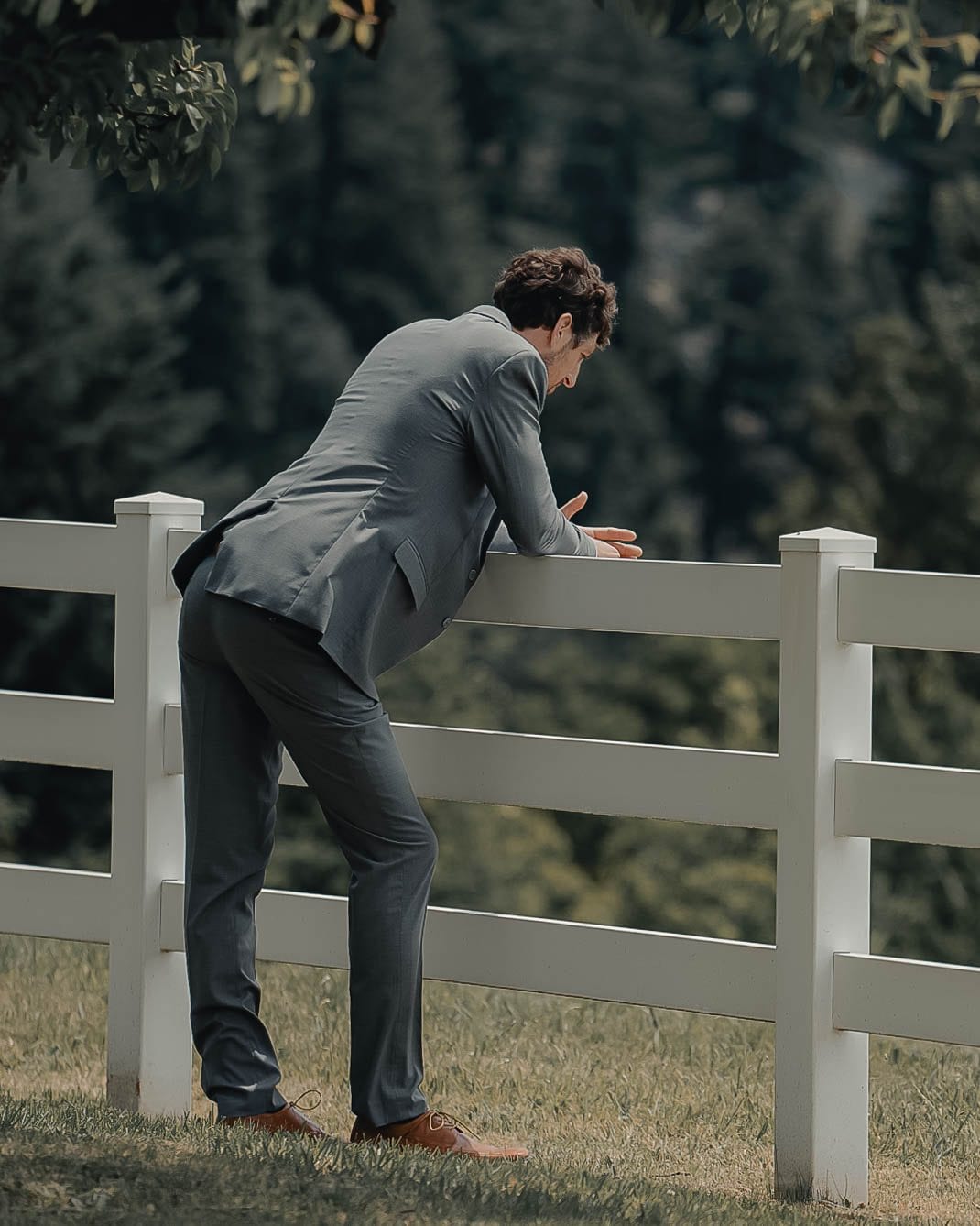 The groom waiting at the fence before the first look
