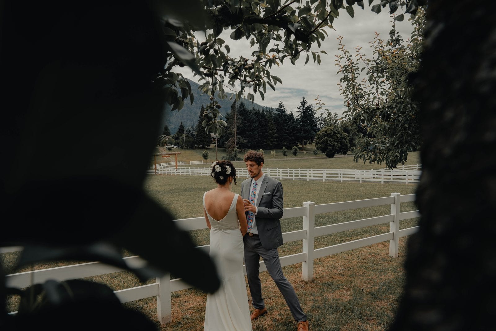 The couple's first look by the white fence