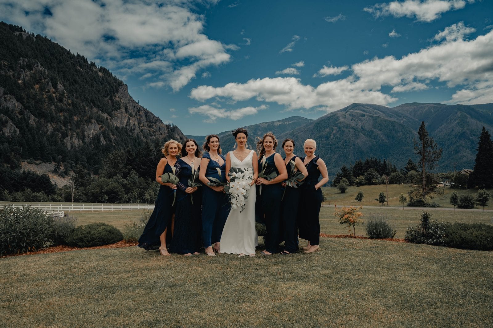 The bride with her bridesmaids, mountains behind