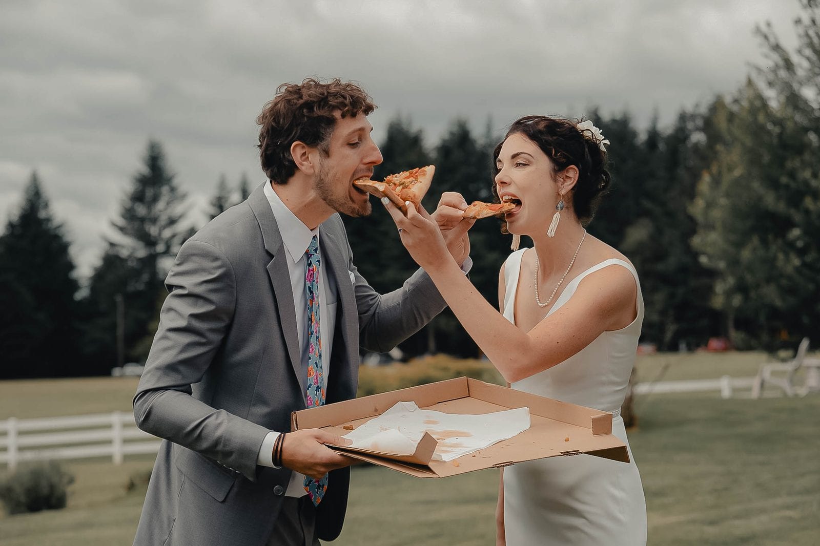 The newlyweds sharing a slice of pizza
