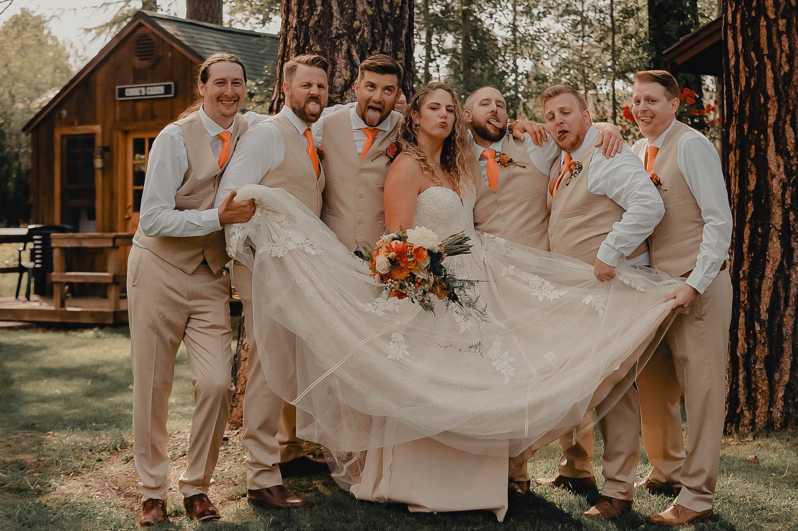 The wedding party fanning out the bride's dress