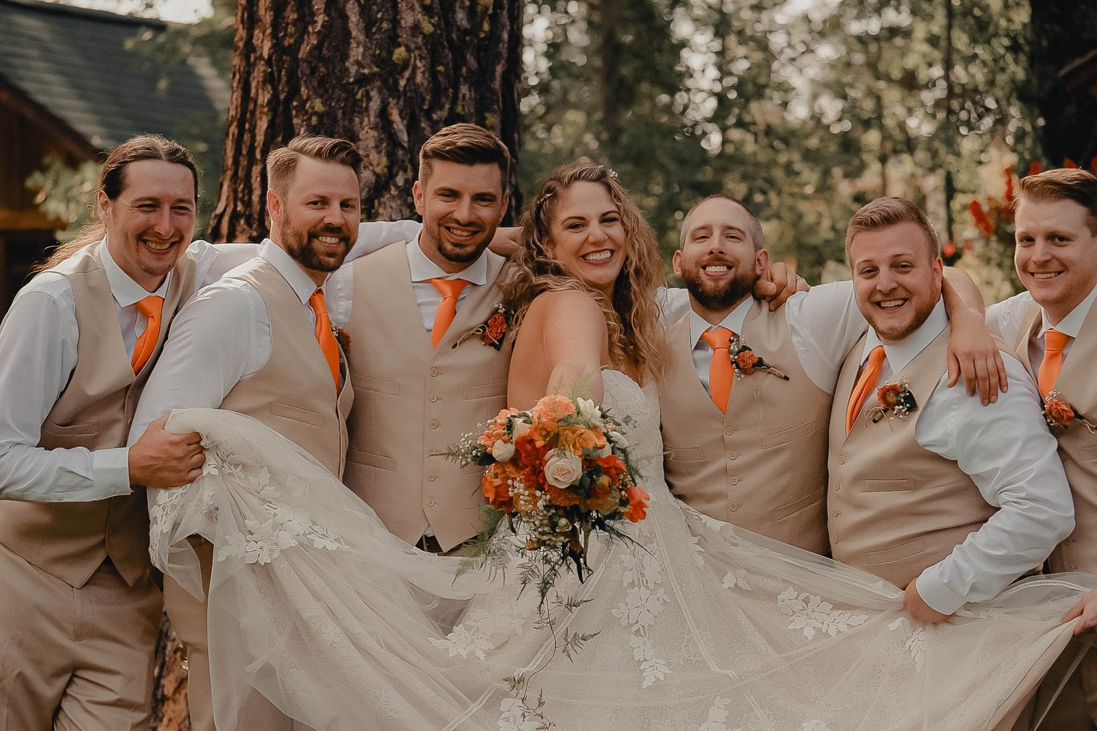 The couple and their wedding party laughing