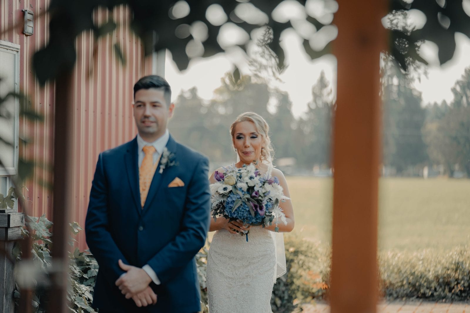 The couple's first look beside the red barn