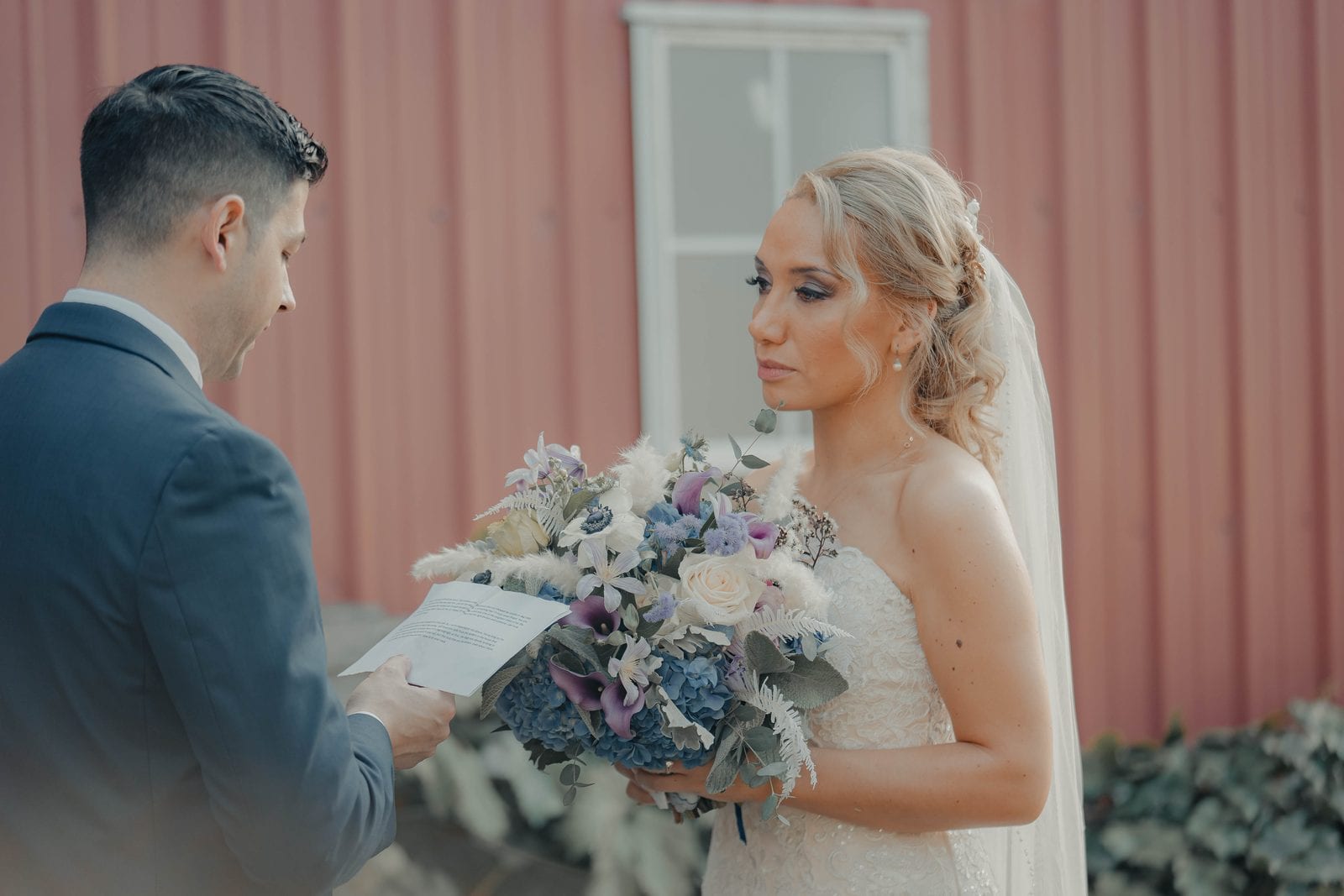 The groom reading his vows aloud